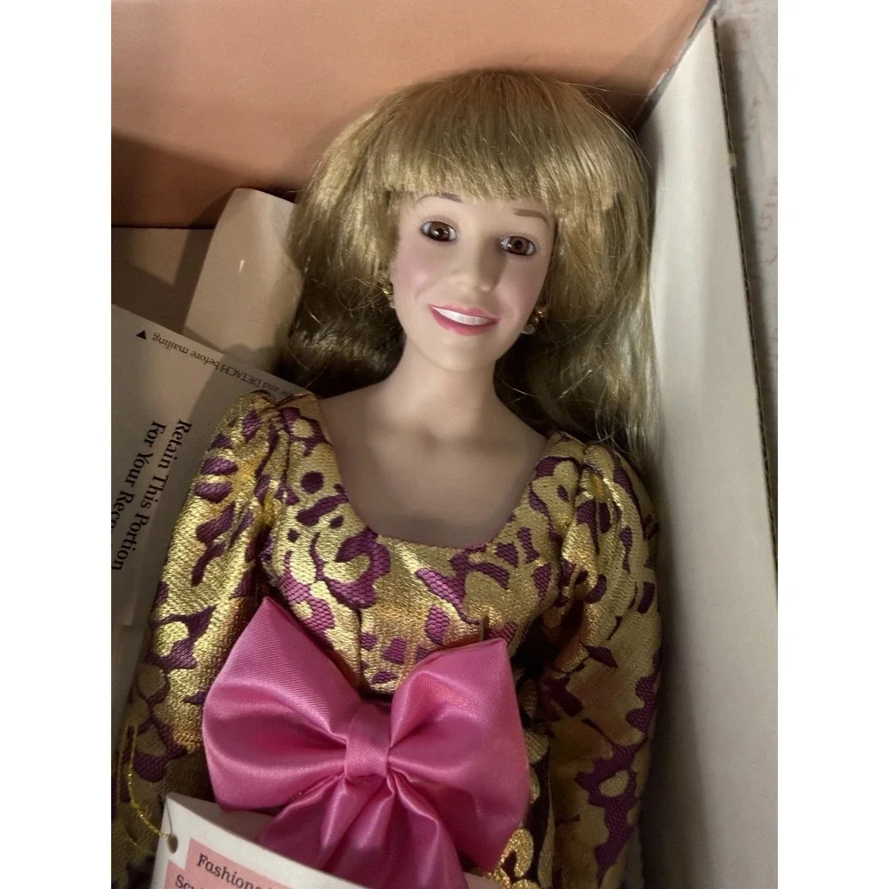 Vintage 90s Vanna White porcelain doll, gold‎ w/ purple bow, still in box!